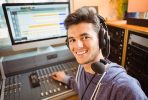 Student mixing audio in a studio